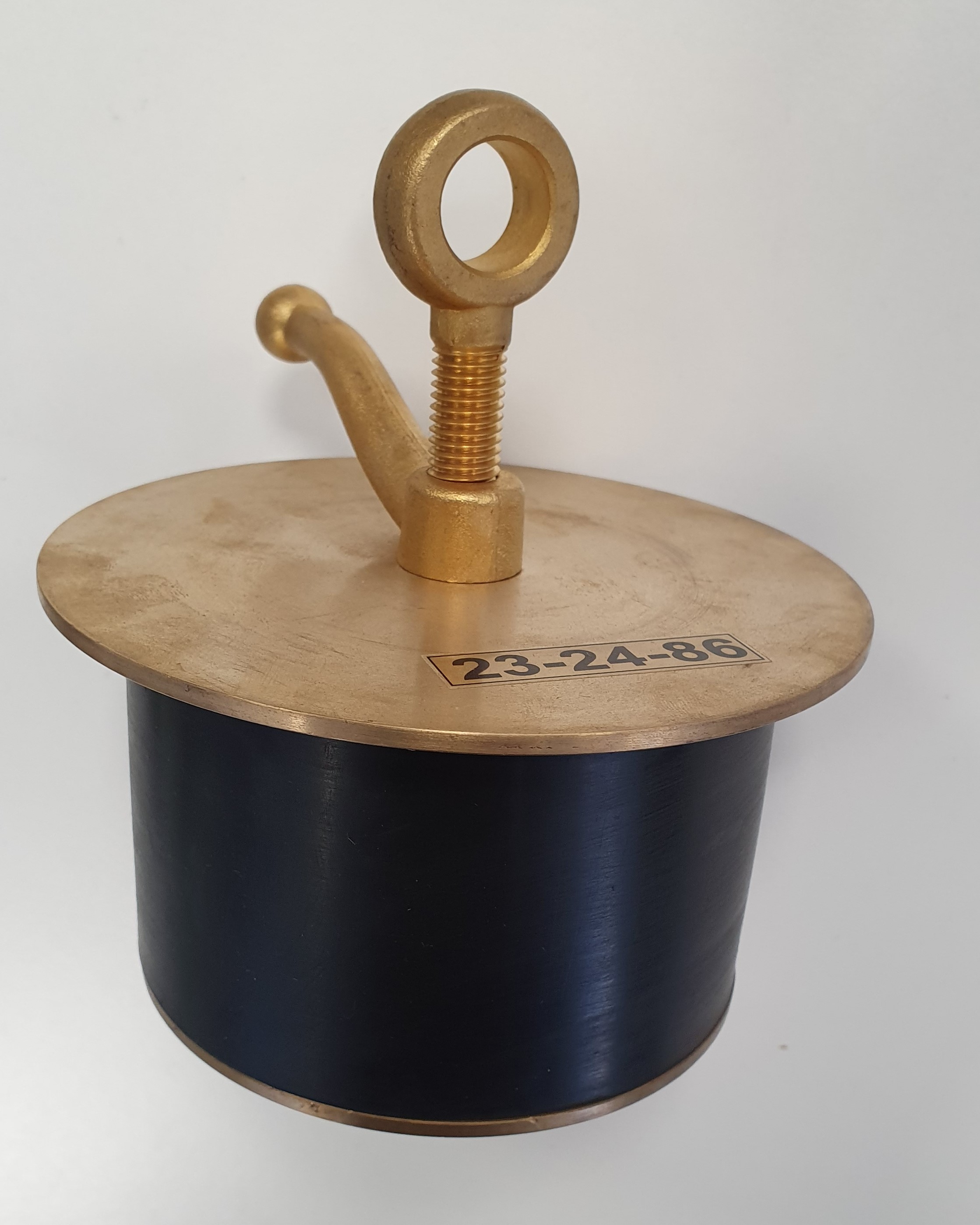 Close-up of a brass scupper plug with black oil-resistant rubber sleeve